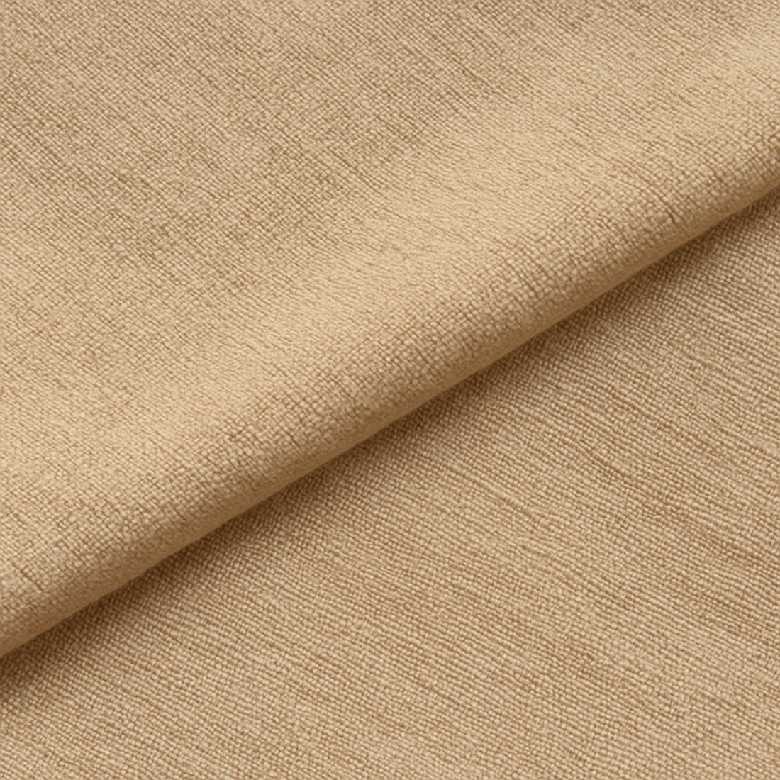 Close-up van zachte beige babystof, netjes gevouwen