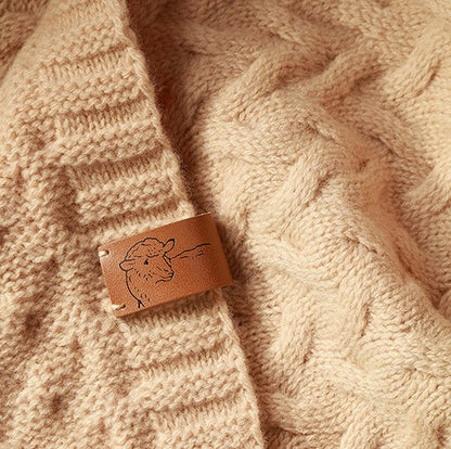 Kabelbreisel en label van de merino wollen babydeken Donkerbeige
